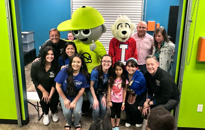 Seven-year-old Mia smiling at her dream birthday party at Urban Air Adventure Park in Arlington, TX, with Make-A-Wish North Texas, ICEE mascot, and Unleashed Brands Foundation volunteers surrounding her in celebration.